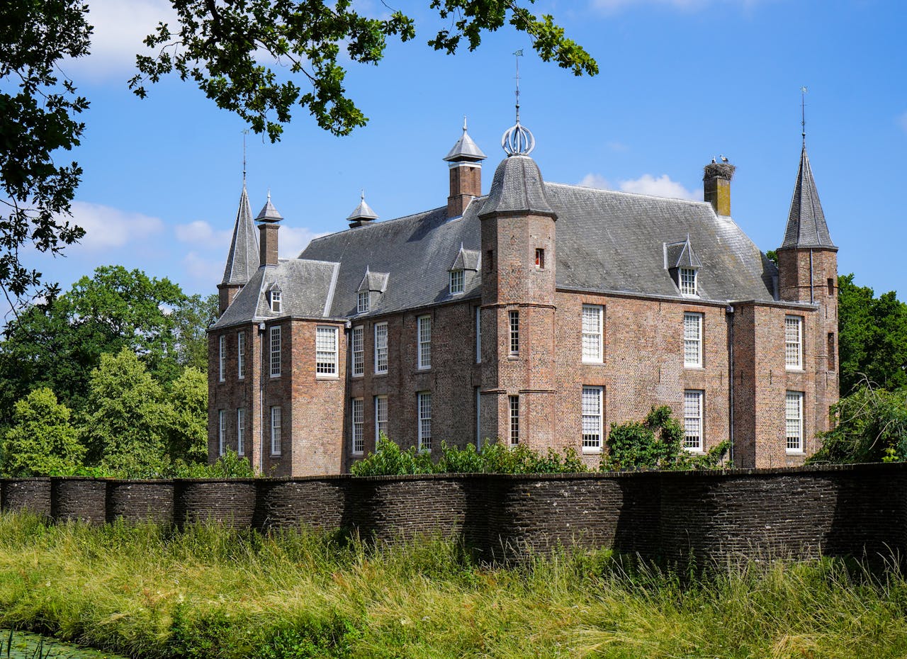 Charming medieval castle in Oud Zuilen, Utrecht under a blue sky.